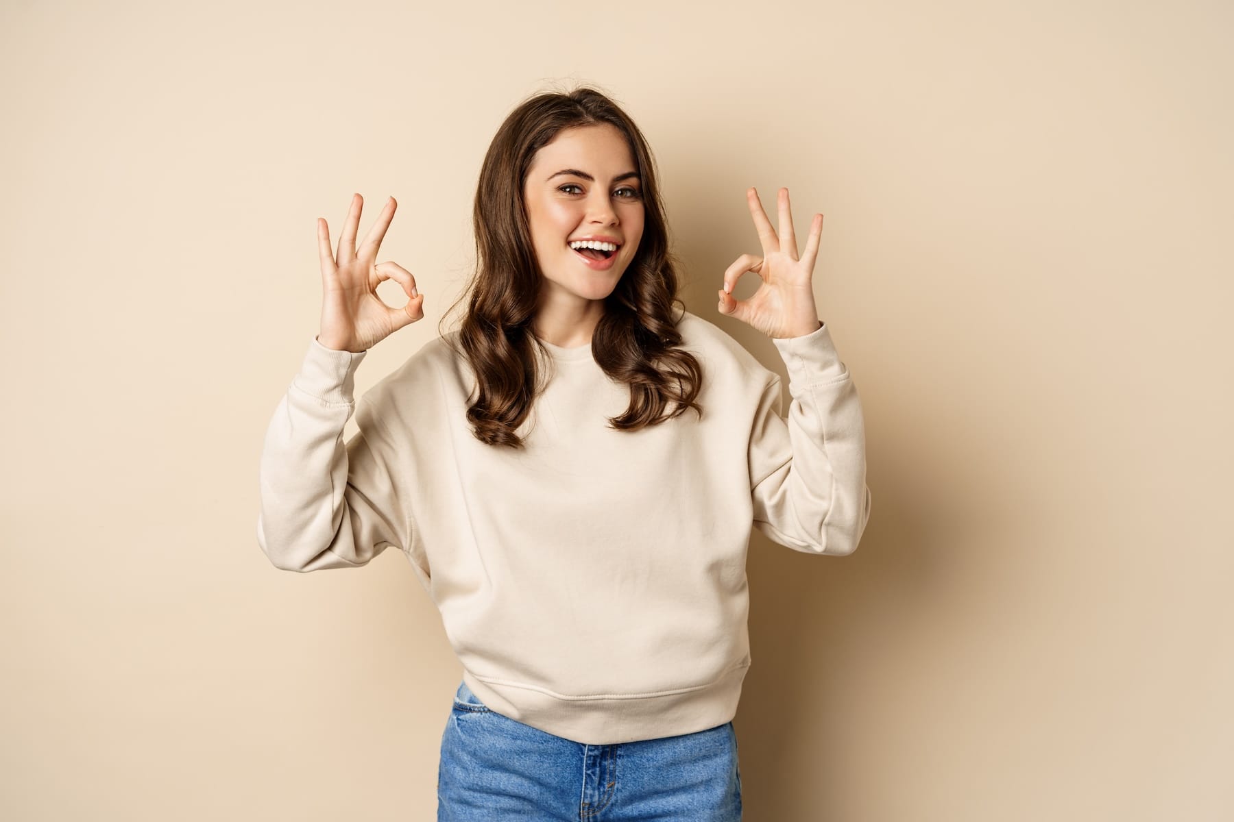 very-good-nice-work-cheerful-young-woman-agrees-shows-okay-ok-praise-recommending-smth-standing-beige-background